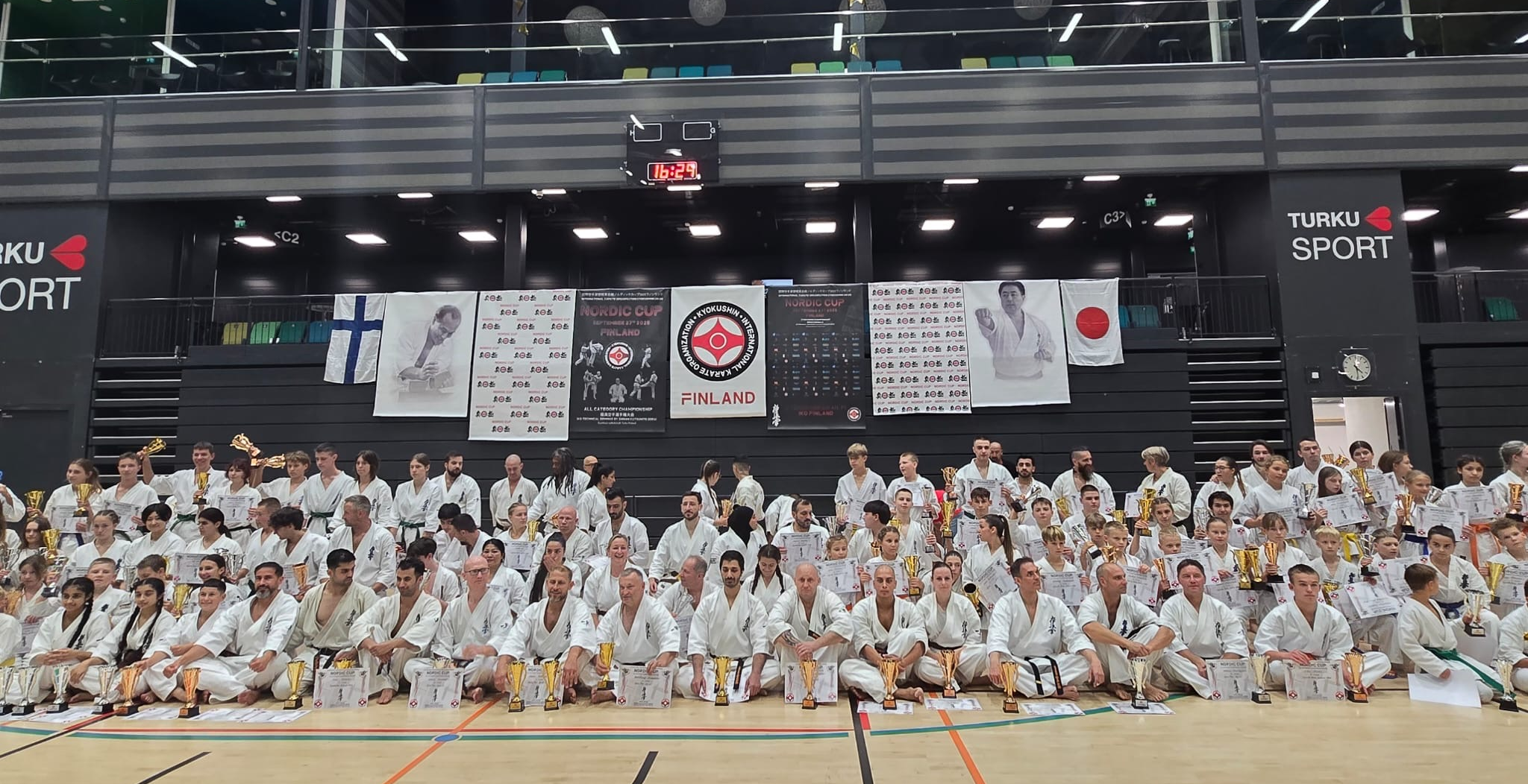 karatecy z Europy siedzą na macie z medalami